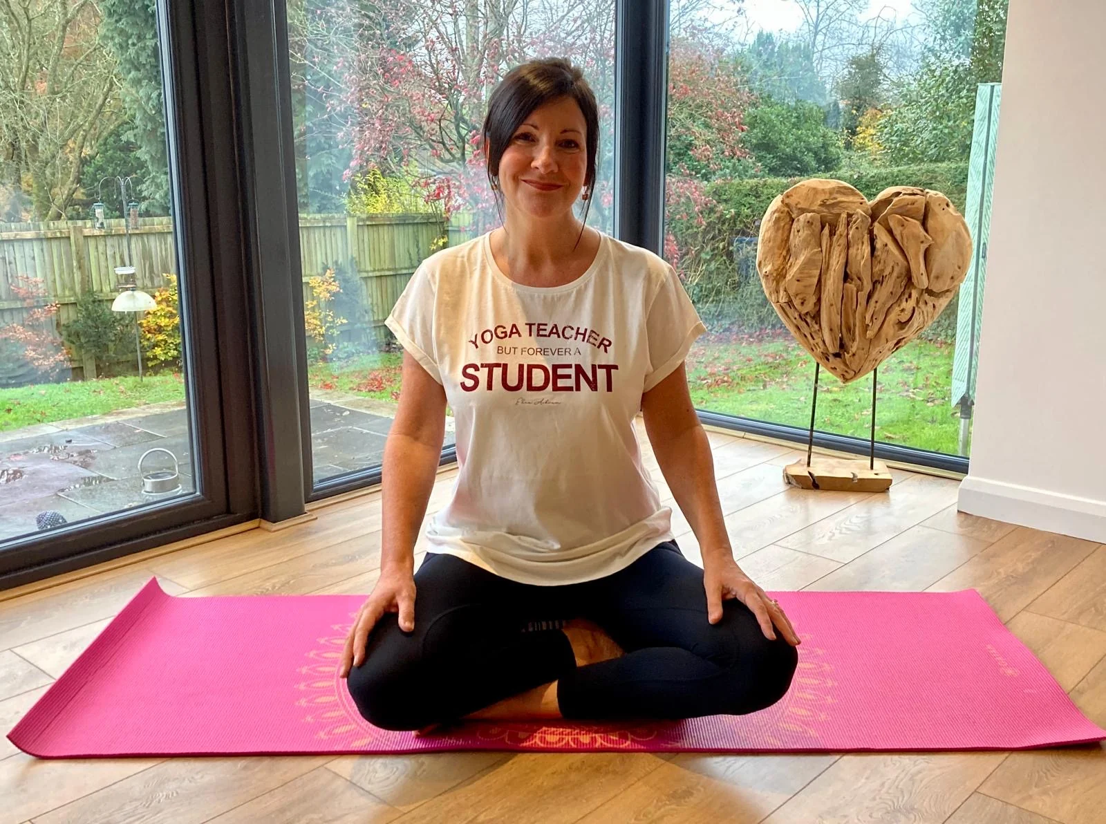 Amanda sitting cross-legged ready to guide a meditation session