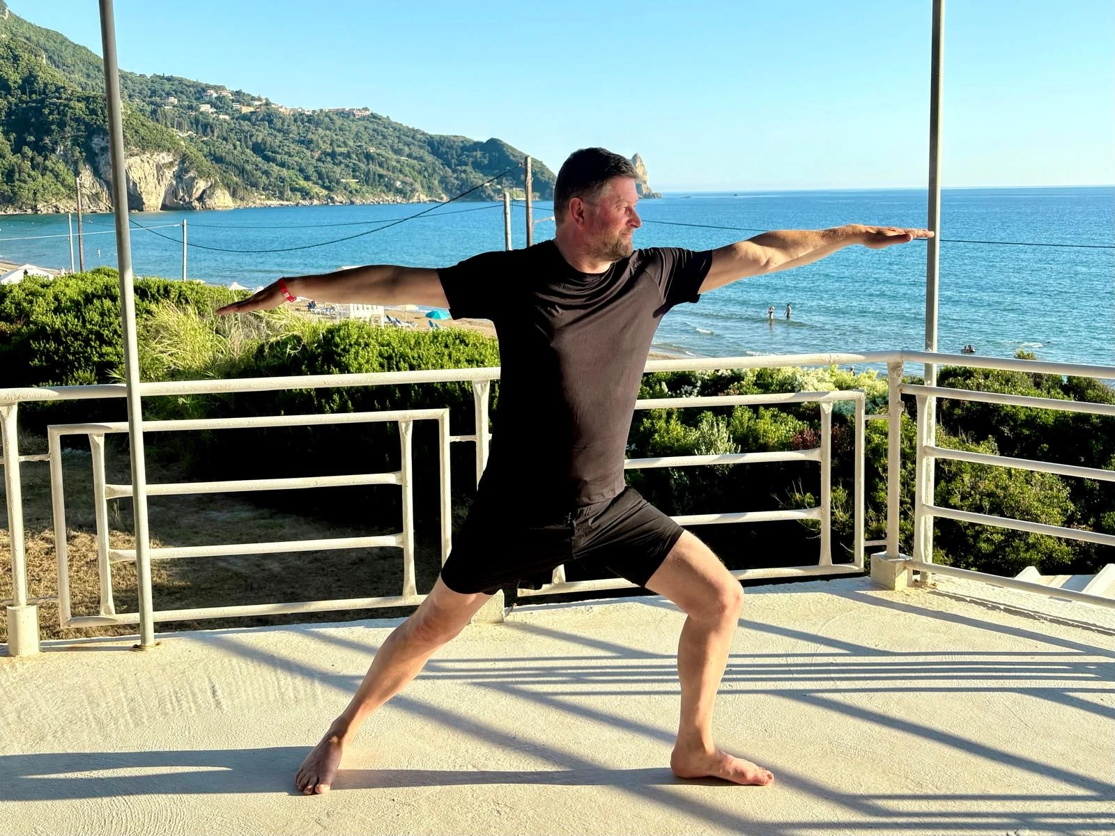 A participant practising an outdoor warrior yoga pose